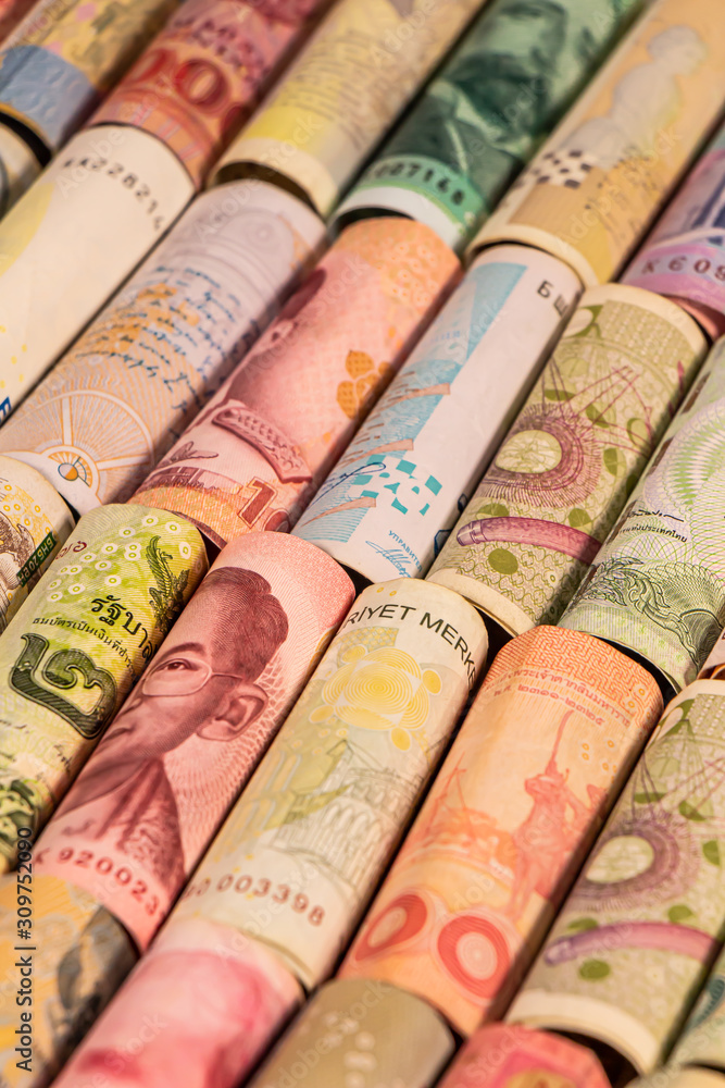 Different banknotes from various countries on rolls Different banknotes from various countries on rolls
