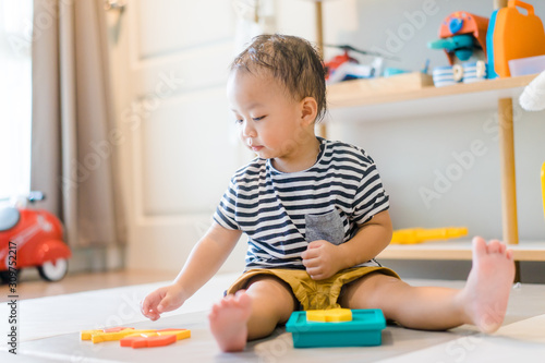 2 years baby boy.Little child boy playing with Shape Creative Puzzle toys block with mother.Kids play with educational toys at home.Day care and Kindergarten school.child development concept.