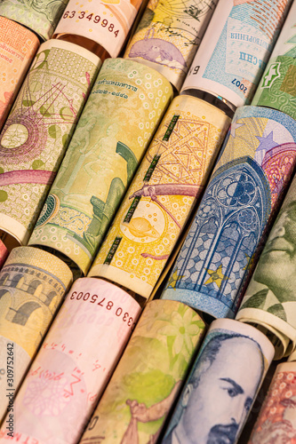 Different banknotes from various countries on rolls