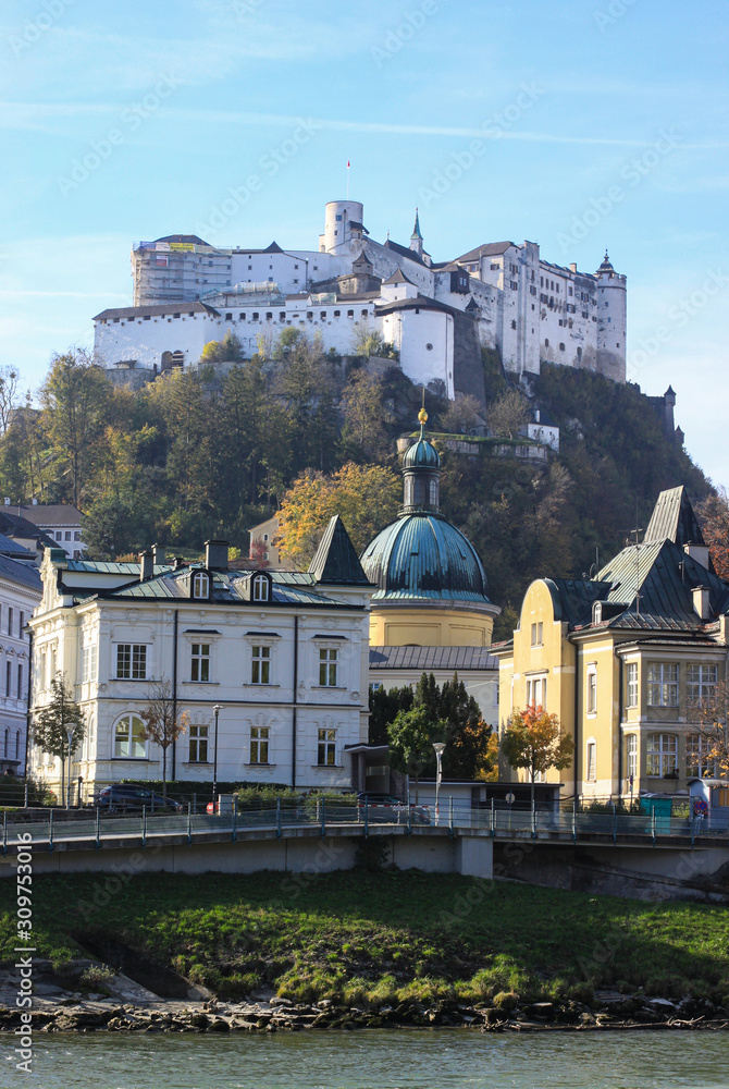 Street view of Salzburg city with castle on the top of hill in autumn day. Salzburg, Austria