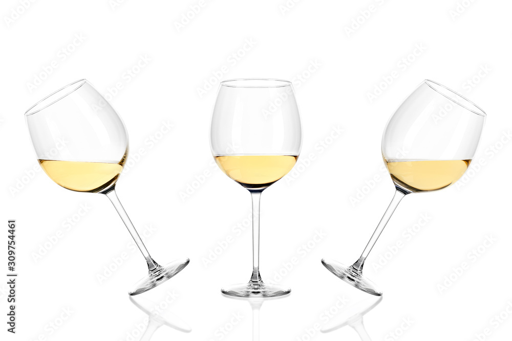 Three glasses of white wine half filled isolated on white background. Three glasses of white wine half filled isolated on white background.