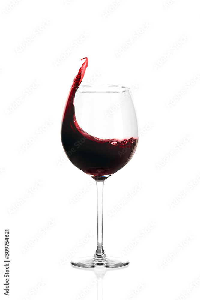 Glass of red wine isolated on white background. Wine spills out of the glass. Glass of red wine isolated on white background. Wine spills out of the glass.
