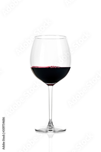 A glass of red wine half filled, isolated on a white background.