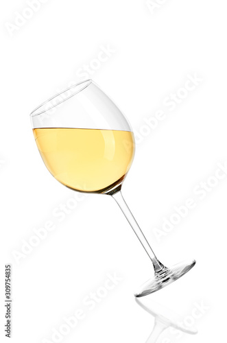 Full glass of white wine isolated on white background. The glass is tilted in.