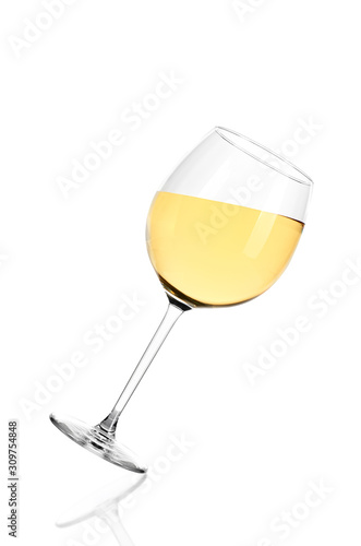 White wine on white backgroundFull glass of white wine isolated on white background. The glass is tilted to the right. photo