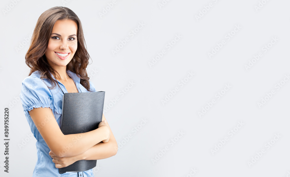 Portrait of happy confident woman with black folder, over grey background, with blank copy space area for advertising slogan or text. Brunette girl in business concept picture. Portrait of happy confident woman with black folder, over grey background, with blank copy space area for advertising slogan or text. Brunette girl in business concept picture.