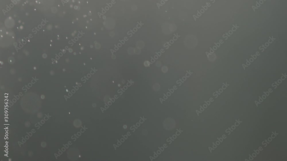 Slow motion of fine dust particles falling on black background Slow motion of fine dust particles falling on black background