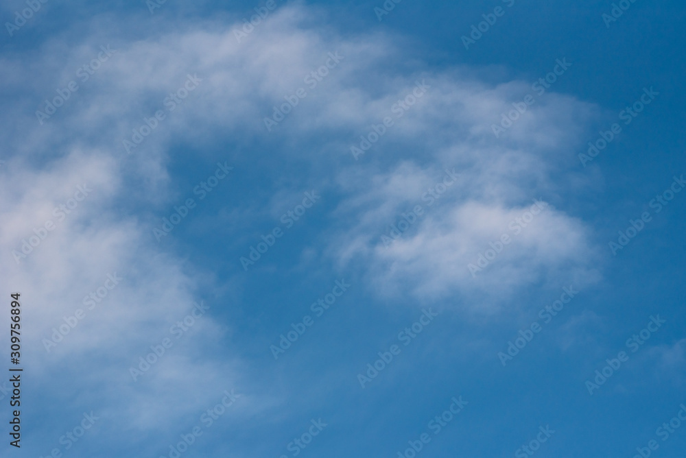 Abstract background with white clouds on blue sky