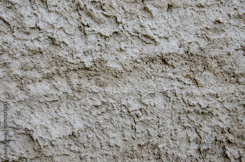 Fototapeta premium Cement plaster fur coat. Street plaster on the wall. Texture, large bumps. Gray empty background. Decoration of facades of buildings.