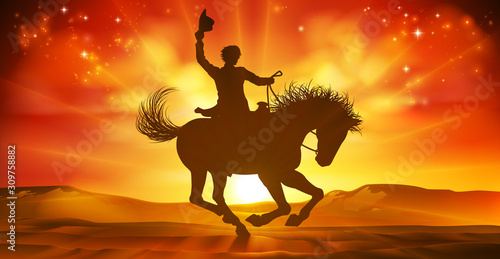 A cowboy riding a horse in silhouette against a desert landscape sunset background