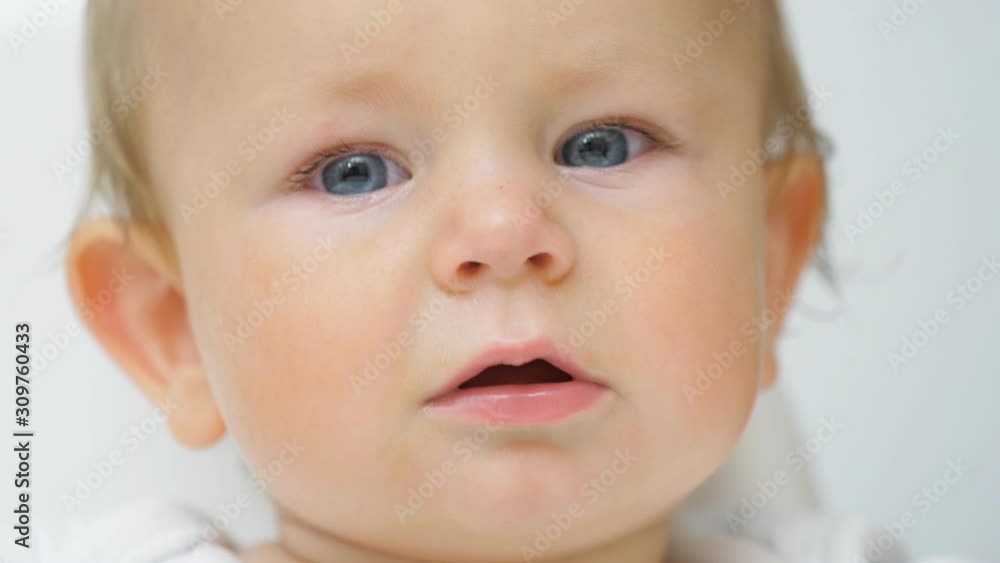 Portrait of cute little blond baby with blue eyes, joyful then angry Portrait of cute little blond baby with blue eyes, joyful then angry