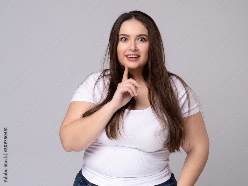Girl holds finger at mouth urging to keep silence Girl holds finger at mouth urging to keep silence