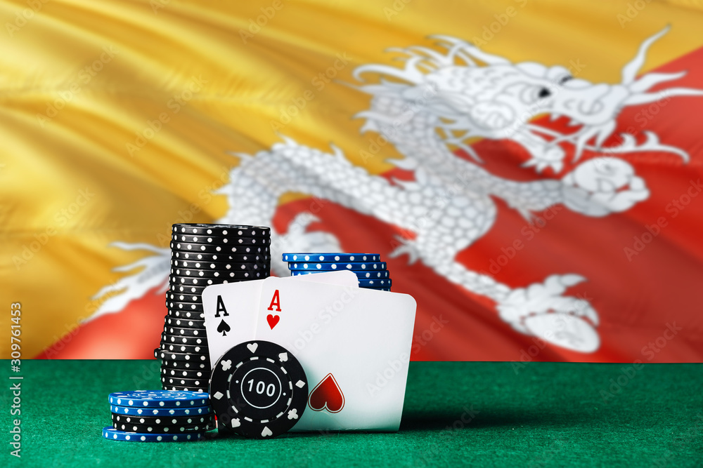 Bhutan casino theme. Two ace in poker game, cards and black chips on green table with national flag background. Gambling and betting.