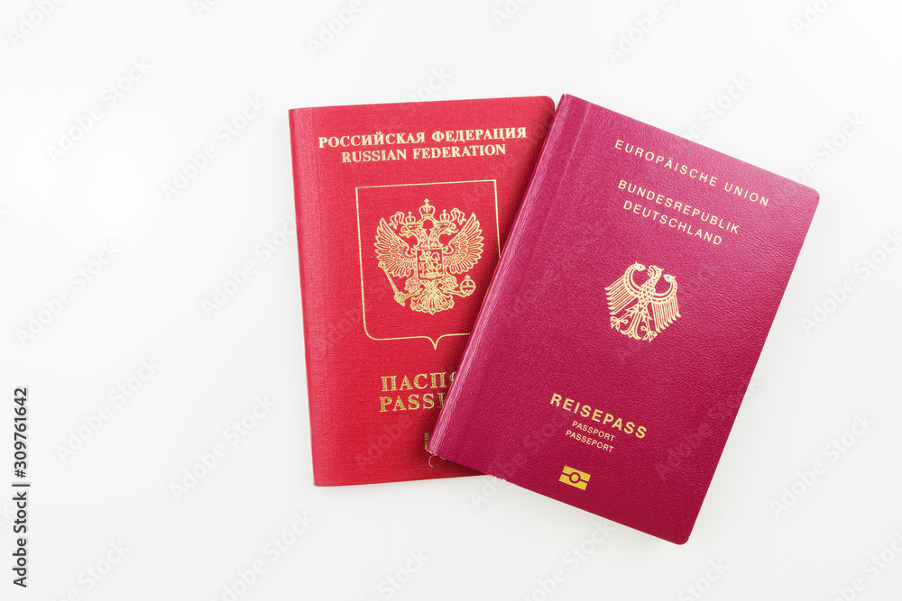 russian-passport-behind-german-passport-isolated-on-white-background