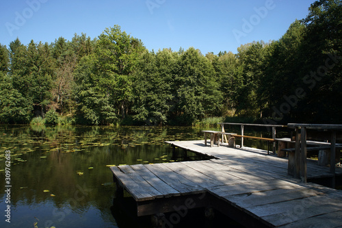 Wooden, old fishing pier on the lake in the forest