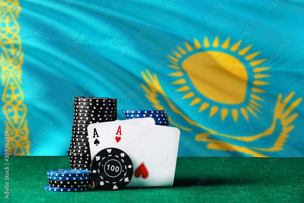 Kazakhstan casino theme. Two ace in poker game, cards and black chips on green table with national flag background. Gambling and betting.