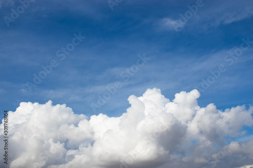 Blue sky background with big fluffy clouds