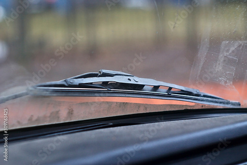 The wiper on a dirty car glass
