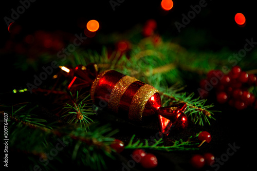 Christmas toys  with green Christmas tree on dark background with lights