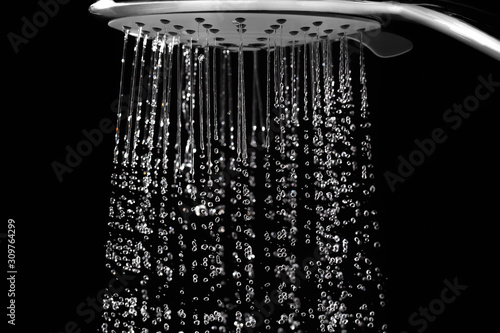Water jets from the shower on black photo