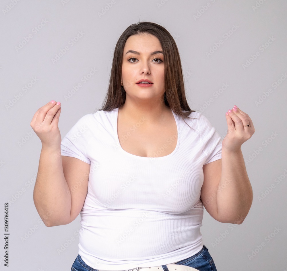 Plus Size Model with long hair meditates in studio. Plus Size Model with long hair meditates in studio.