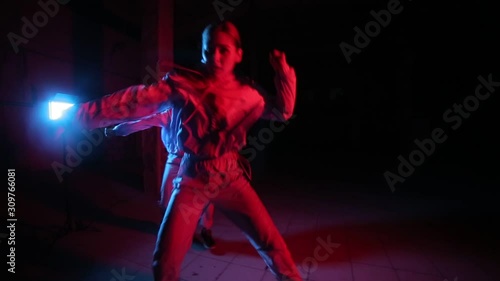 duet of young beautiful girls dancing hip hop, street dancing in the studio on a black background, isolated