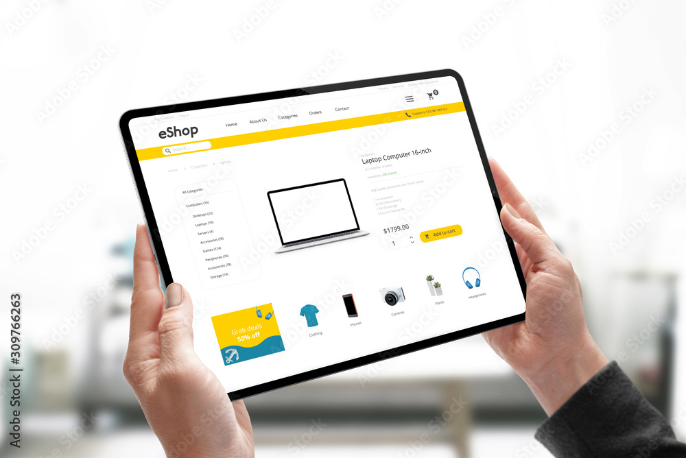 Online shopping website concept on tablet in woman hands. Woman search for laptop computer online. Online shopping website concept on tablet in woman hands. Woman search for laptop computer online.
