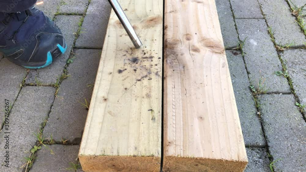 Closeup view of person trying to light fire on wooden plank. Closeup view of person trying to light fire on wooden plank.