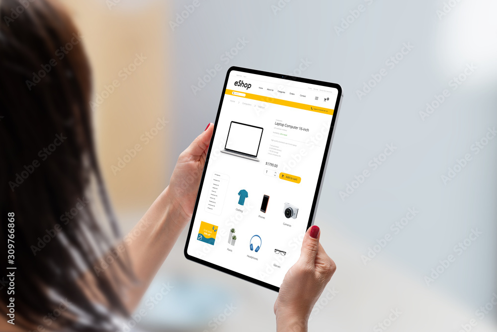 Modern online shop on tablet display in woman hands. Flat design e-commerce web site with technology products. Concept of shopping online Modern online shop on tablet display in woman hands. Flat design e-commerce web site with technology products. Concept of shopping online