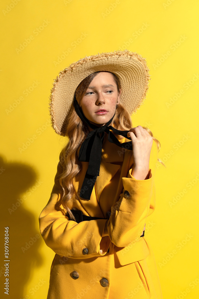 Pretty blonde girl with freckles in yellow outfit and straw hat Pretty blonde girl with freckles in yellow outfit and straw hat