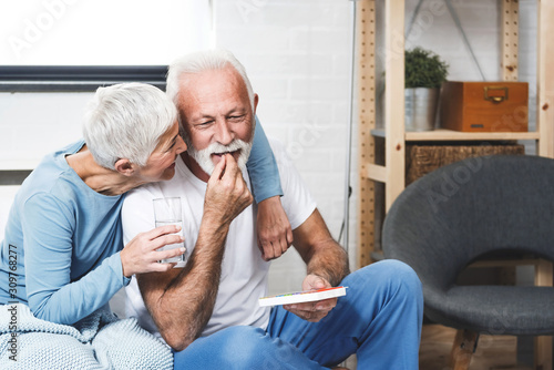 Elderly couple taking medication photo