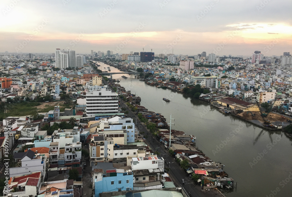 Aerial view of Saigon cityscape under sunset sky.