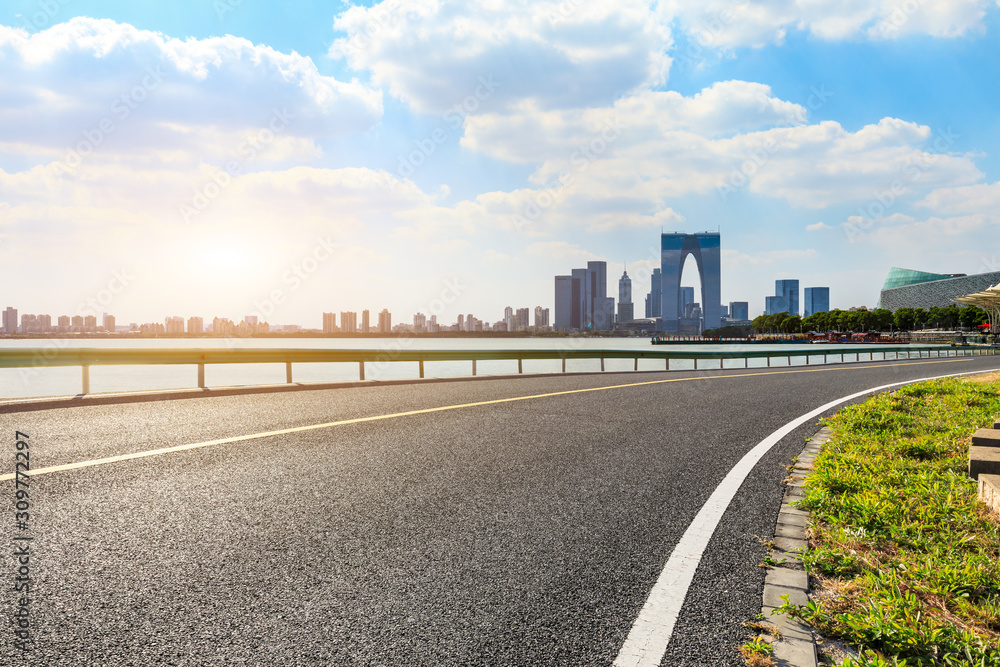 Asphalt highway and Suzhou city skyline on a sunny day. Asphalt highway and Suzhou city skyline on a sunny day.