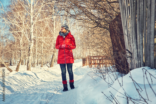 Fototapeta Naklejka Na Ścianę i Meble -  walking woman in a hat and scarf in the winter.