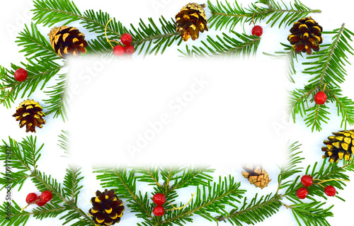 Christmas frame of spruce branches, red berries, cones. Flat lounger, top view, copy space.