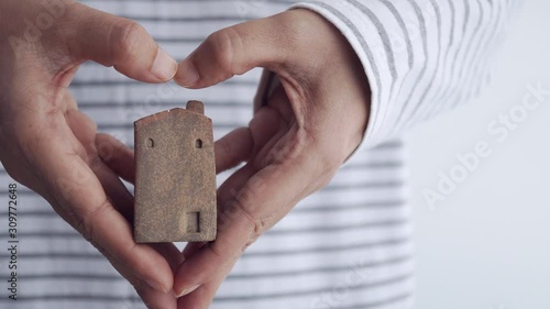 brown home model holding by family man, home sweet home concept