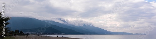 Panoramic view of the mountains and the sea. Sequential mountains covered wit...