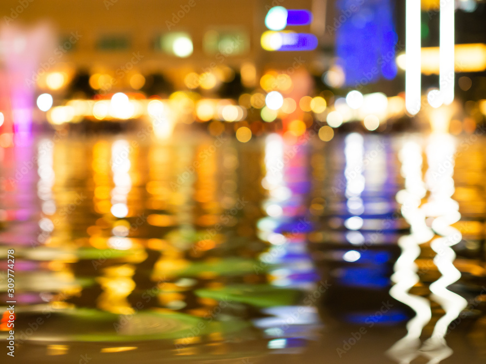 Colourful blur. Reflection light in water. Nightlife in city center