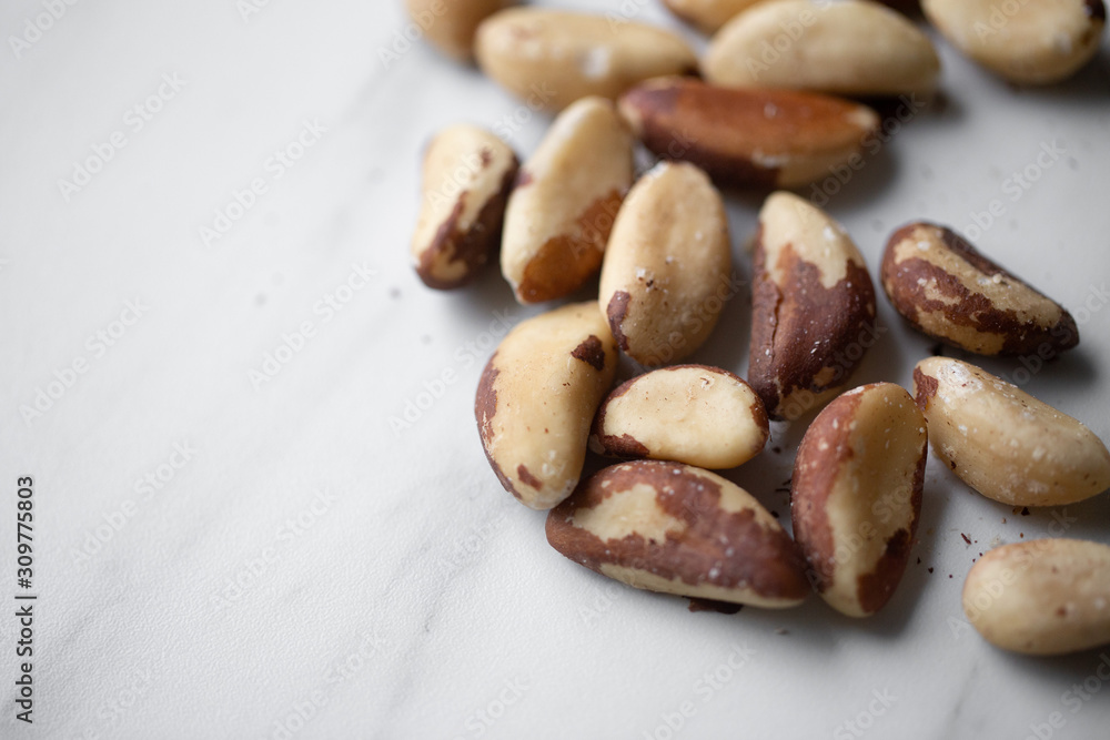 Brazil nuts on white marble background Brazil nuts on white marble background