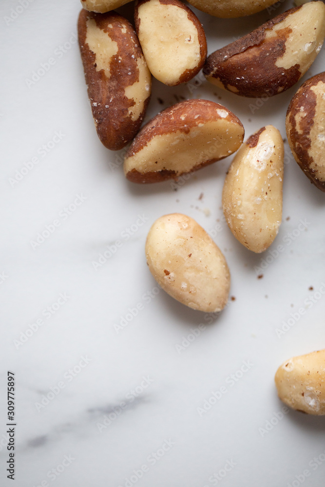 Brazil nuts on white marble background Brazil nuts on white marble background