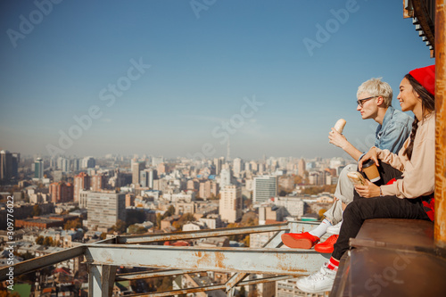 Lovely couple having lunch while sitting on rooftop