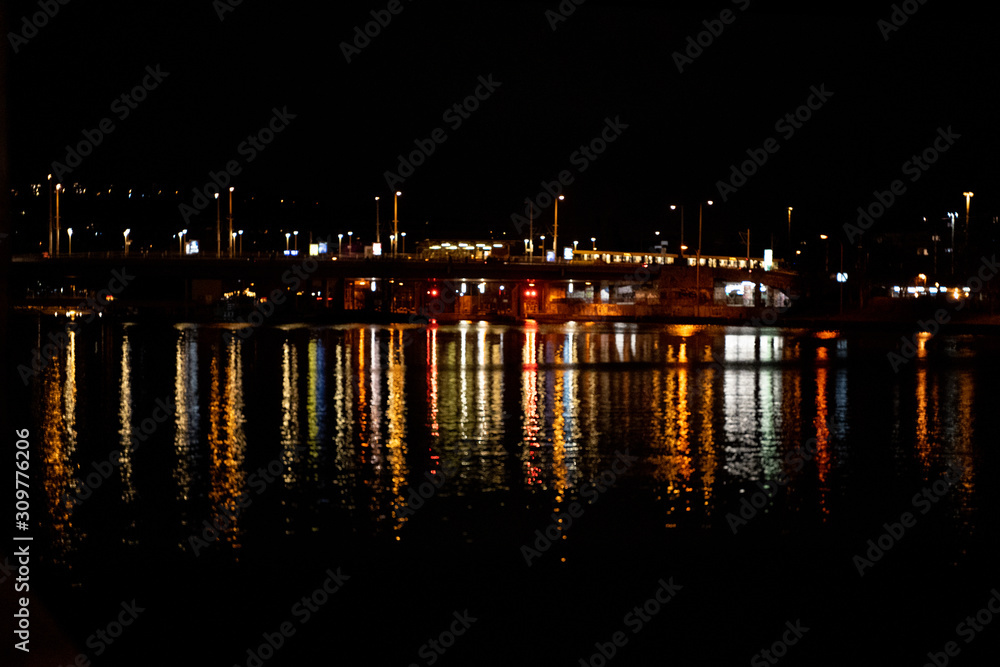 traffic on bridge over river at night