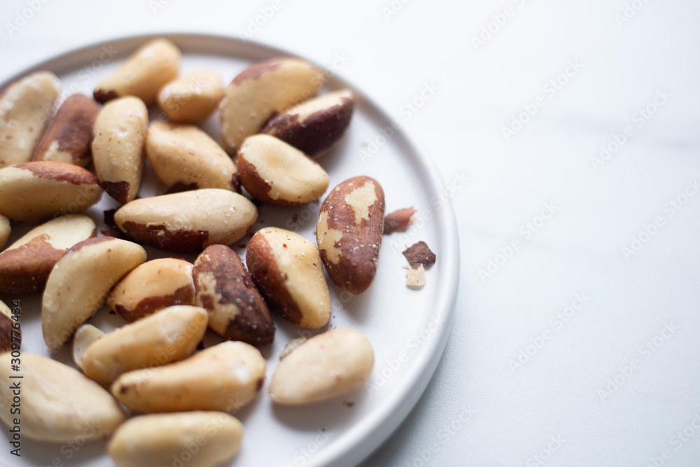 Brazil nuts on white marble background Brazil nuts on white marble background