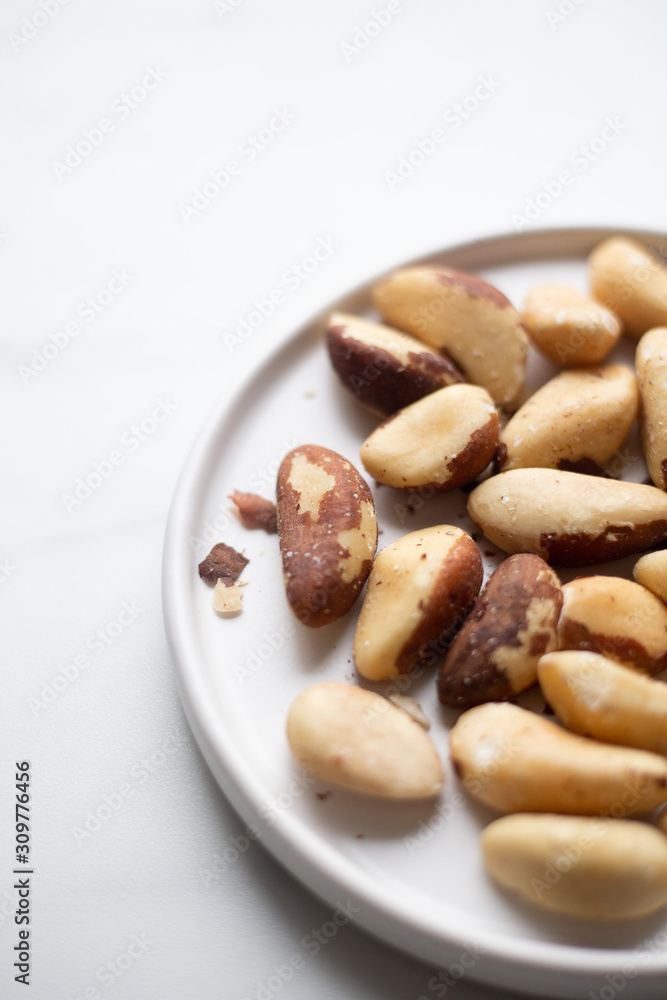 Brazil nuts on white marble background
