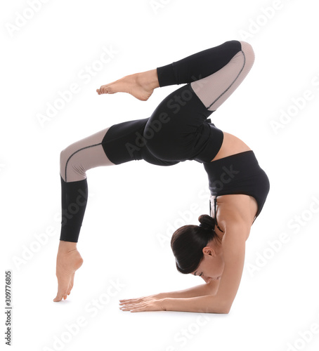 Professional young acrobat exercising on white background