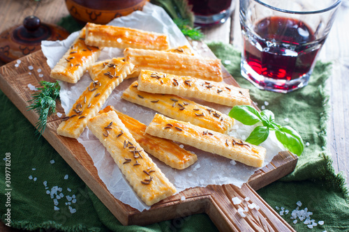 Salty cookies with caraway seeds on a wooden board, selective focus