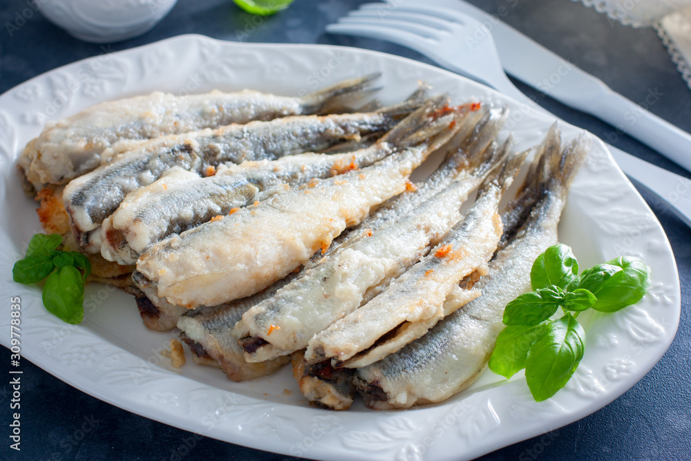 Fried smelt on a white dish, selective focus Fried smelt on a white dish, selective focus