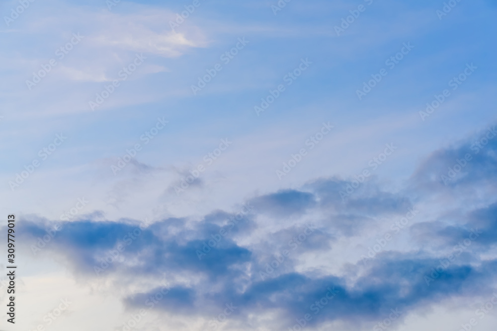 Beautiful puffy clouds at sunset isolated against pastel blue and pink skies Beautiful puffy clouds at sunset isolated against pastel blue and pink skies