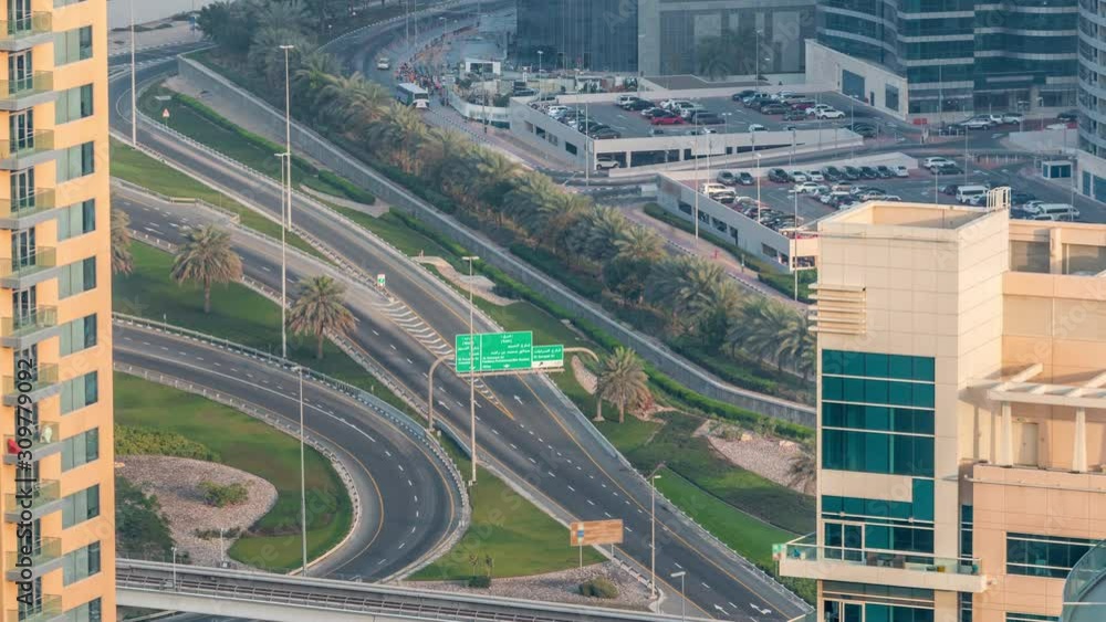 Aerial view of a road intersection in a big city timelapse. Urban landscape of Dubai Marina and JLT district in UAE with cars and metro Aerial view of a road intersection in a big city timelapse. Urban landscape of Dubai Marina and JLT district in UAE with cars and metro