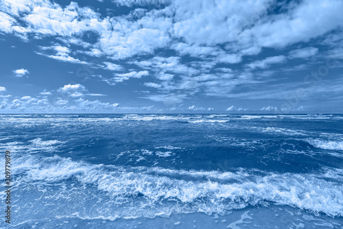 Beautiful dramatic seascape with stormy sea. View on Baltic sea, sand beach and sky with clouds. Summer background.